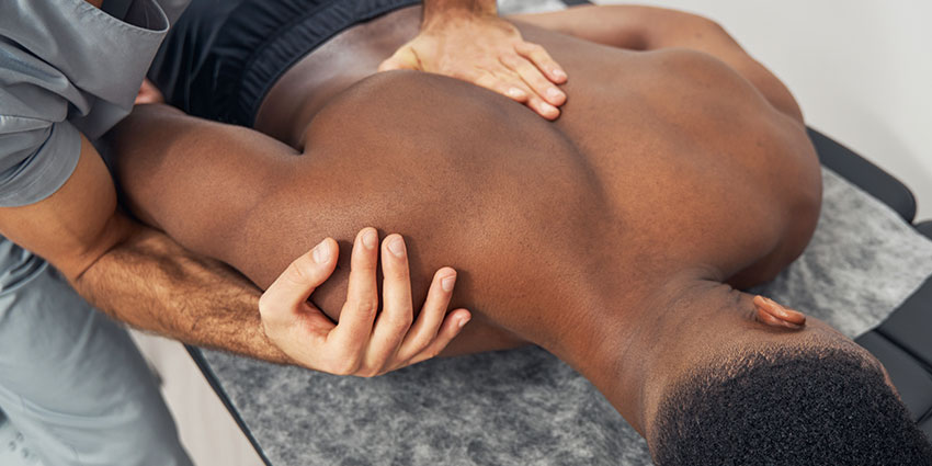 Southeast Florida auto accident forms for chiropractor adjusting patient's shoulder to relieve pain