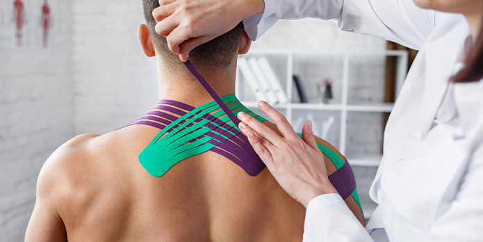 patient getting kinesio tape as an auto accident injury treatment in Southeast Florida